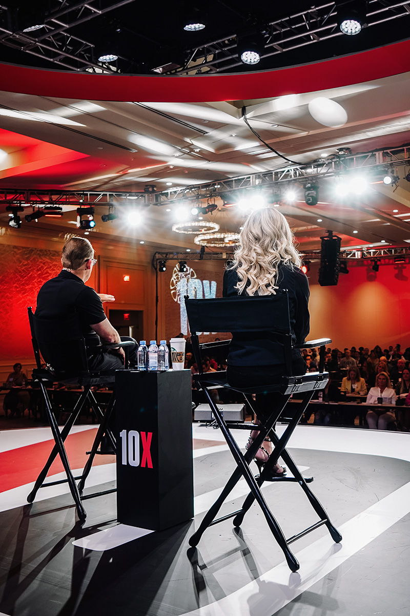 Natalie and Brandon Dawson on stage during a 10X event