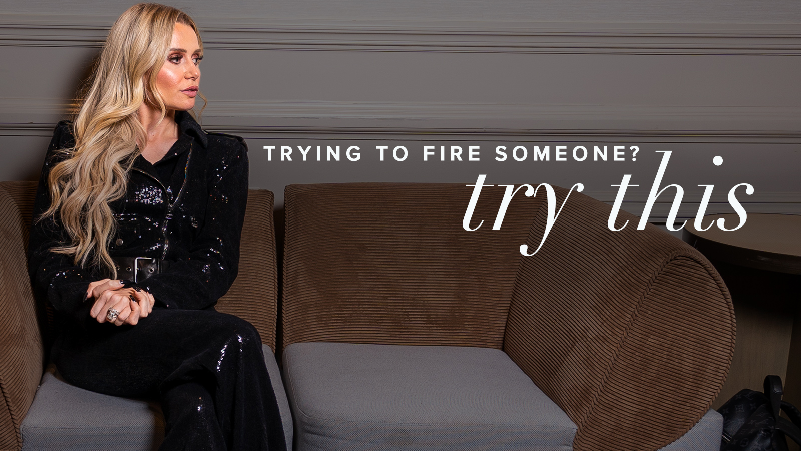 Natalie Dawson, dressed in all black, sits on the left side of a brown and gray corduroy couch, looking to her left toward the title, "Trying to fire someone? Try this!"