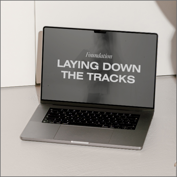 Laptop with "Laying down the tracks" on screen
